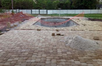 backyard swimming pool under construction - lying deck